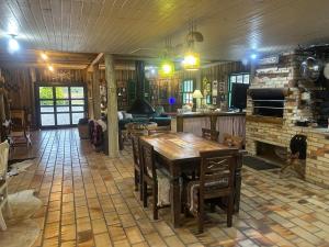 a living room with a wooden table and a fireplace at Estalagem Carucacas in Bom Jardim da Serra