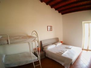 a bedroom with two bunk beds and a window at Residenza Marconi's Nest in Siculiana