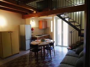a kitchen with a table with chairs and a refrigerator at Residenza Marconi's Nest in Siculiana