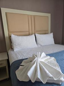 a bed with a white towel on top of it at Lido System Makonde Village in Thohoyandou