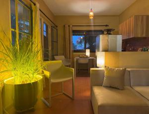 a living room with a couch a chair and a table at Résidence NATANGUE 1 - Studio La Bella in Sali Nianiaral