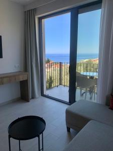 a living room with a view of the ocean at REZEVICI BOUTIQUE VILLA in Petrovac na Moru