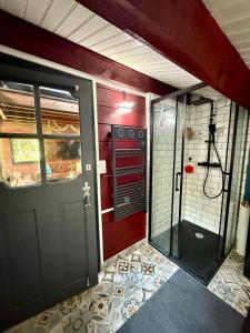 a bathroom with a shower and a door in a room at Chalet front de mer in Pénestin +4 photos