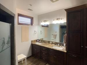a bathroom with a sink and a large mirror at Ranch stay near Sequoias in Woodlake +14 photos
