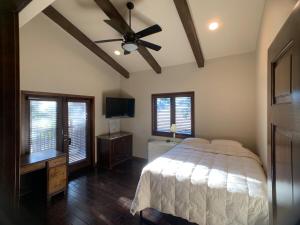 a bedroom with a bed and a ceiling fan at Ranch stay near Sequoias in Woodlake