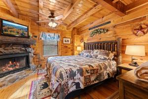 a bedroom with a bed and a fireplace at Cozy Mountain Cabin Getaway with Hot Tub for 4 Guests in Pigeon Forge