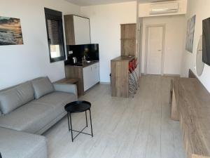 a living room with a couch and a table at REZEVICI BOUTIQUE VILLA in Petrovac na Moru