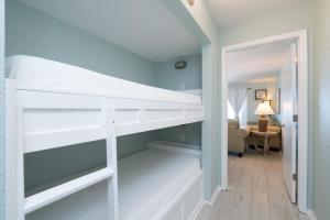 a white bunk bed in a room with a desk at 1BR Sleeps 5 at The Summit with Ocean Front Views in Panama City Beach +57 photos