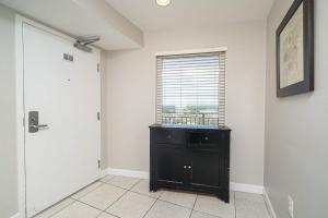 a room with a black dresser and a window at Beachfront Haven 2 BDR Kid-Friendly Resort in Panama City Beach