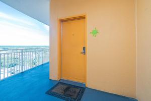 a room with a yellow door on a balcony at Beachfront Haven 2 BDR Kid-Friendly Resort in Panama City Beach