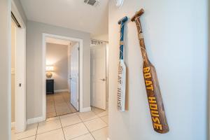a baseball bat hanging on a wall in a hallway at Beachfront Haven 2 BDR Kid-Friendly Resort in Panama City Beach +41 photos