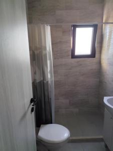 a bathroom with a toilet and a window at Beautiful view apartment Tivat in Tivat +10 photos