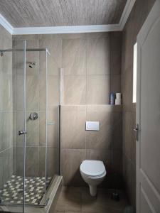 a bathroom with a shower and a toilet at Lido System Makonde Village in Thohoyandou