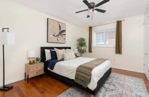 a bedroom with a bed and a ceiling fan at Huge 4 Bedroom House Near Square One - Sleeps 8 in Mississauga