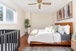 a bedroom with a bed and a ceiling fan at Huge 4 Bedroom House Near Square One - Sleeps 8 in Mississauga