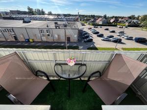 a balcony with a table and a parking lot at Lagūna in Jēkabpils