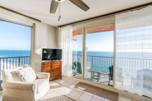 a living room with a view of the ocean at Sunset Shores - Oceanfront Condo Bliss in Panama City Beach