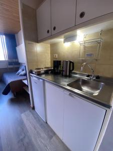 a kitchen with a sink and a counter top at Studio 4 pax, Edificio Cirrus 950 in Las Lenas +21 photos