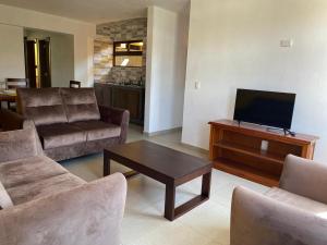 a living room with a couch and a tv at La Casa de los Abuelos in Zacatlán