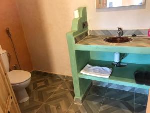 a bathroom with a sink and a toilet at Dar Talhaya in Oulad Driss +38 photos