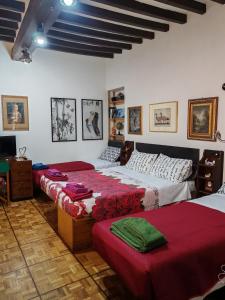a bedroom with two beds and a television in it at Studio Borgo Colonne in Parma