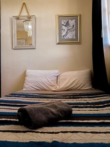 a bed with a blanket on it in a bedroom at Dalia Room, Paseo Durango in Durango