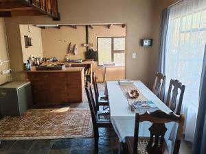 a dining room with a table and chairs in a kitchen at Mali Mali Safari Lodge House 5 in Hoedspruit