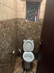 a bathroom with a toilet with a window in it at Epizone in Mokopane