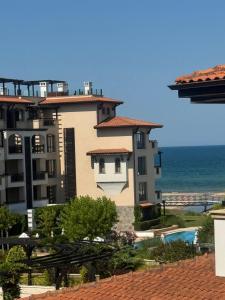 a large apartment building with a view of the ocean at Oasis Beach Lozenets 1 bed in Lozenets