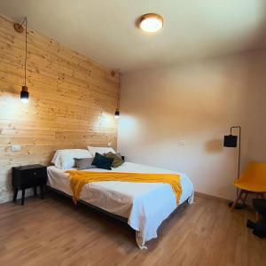 a bedroom with a large bed with a wooden wall at Villa Rosina in Saint Vincent