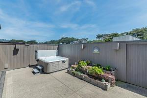 a backyard with a heater on the side of a fence at La Costiera Ocean & Bluff Views With Hot Tub in Sea Ranch