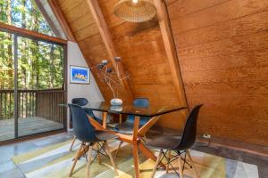 a wooden dining room with a table and chairs at Star Nest - Secluded Forest Property in Gualala +19 photos