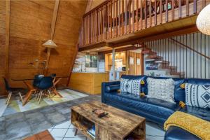 a living room with a blue couch and a table at Star Nest - Secluded Forest Property in Gualala