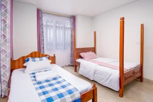Ένα ή περισσότερα κρεβάτια σε δωμάτιο στο Daisy Katani Homes