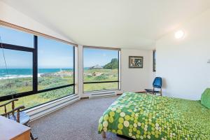 a bedroom with a bed and a view of the ocean at Haltwhistle West With Ocean Views in Sea Ranch +21 photos