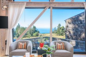 a room with two chairs and a large window at Architectural Treasure - Private Hot Tub in Sea Ranch +24 photos