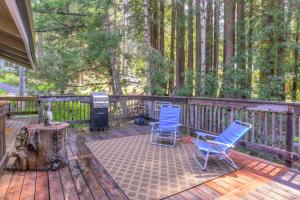 two chairs and a table on a deck with trees at Searenity by the Sea - Private Hot Tub in Gualala