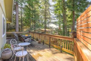 a wooden deck with a table and chairs on it at Searenity by the Sea - Private Hot Tub in Gualala