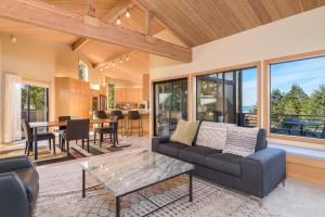a living room with a couch and a table at Riverview - Private Hot Tub - Sleeps 12 in Sea Ranch