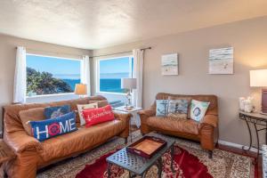 a living room with two couches and a large window at Lucky Ewe - Ocean View Retreat in Gualala +15 photos