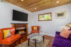 a living room with a tv and a couch and a table at Charming Family 2 BDR for 6 With Ocean Views in Gualala