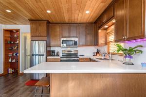 a kitchen with wooden cabinets and a white counter top at Quaint Cottage for 2 With Ocean Views in Gualala