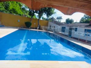 a swimming pool at a hotel with blue water at Cabaña brisa melgar in Melgar