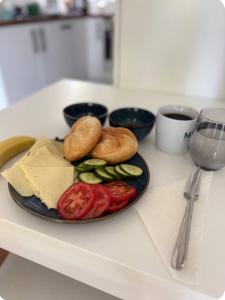 a plate of food with cheese and vegetables on a counter at Cozy room with Breakfast Near the Heart of Graz in Graz