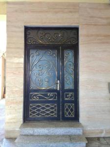 a black door on the side of a building at apartment Leyla in Batumi
