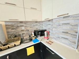 a kitchen with a sink and a counter top at apartment Leyla in Batumi +5 photos