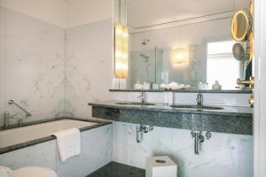 a bathroom with two sinks and a tub and a mirror at Louis C Jacob, Hamburg, Autograph Collection in Hamburg +50 photos