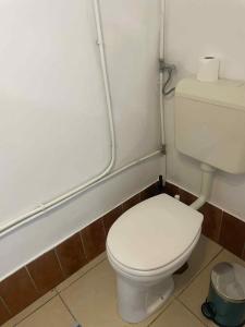 a white toilet in a bathroom with pipes at SióSpot in Siófok