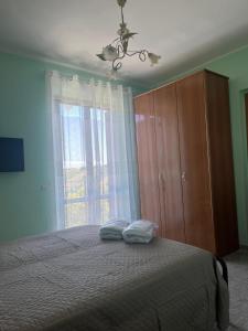a bedroom with a bed with two pillows on it at Dimora i Mandorli 2 in Colonnella