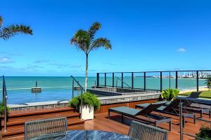 a patio with a view of the beach at Flat pé na areia Alta Garden - MyFlats Hospedagens in Tambaú
